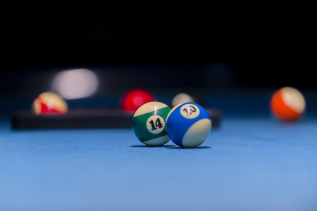 Colorful billiards balls. Billiard ball at blue table. Colorful American pool snooker balls background. American Billiard in bar. Close up Billiard balls. Bar game. Billiard table game.の写真素材