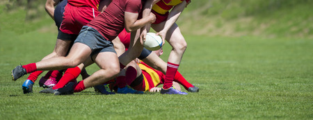 Rugby players fight for the ball on professional rugby stadiumの写真素材