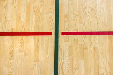 wooden floor badminton, futsal, handball, volleyball, football, soccer court. Wooden floor of sports hall with marking red lines on wooden floor indoor, gym courtの写真素材