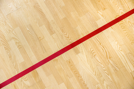 Red line on the gymnasium floor for assign sports court. Badminton, Futsal, Volleyball and Basketball courtの写真素材