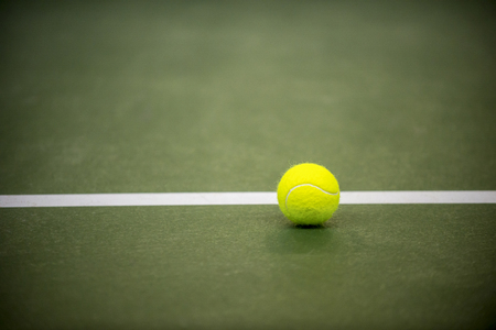 tennis ball on a tennis courtの写真素材