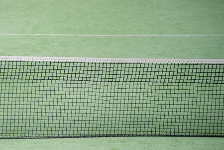 Net of tennis court on green wall backgroundの写真素材