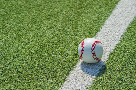 White ball for playing baseball on the grass backgroundの写真素材