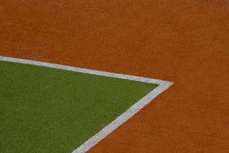 Artificial green and brown turf texture background with white line marksの写真素材