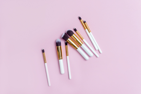 Set of makeup brushes on pink background. Top view point, flat lay. Top viewの写真素材