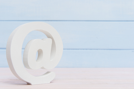e-mail symbol on wooden background with copy spaceの写真素材