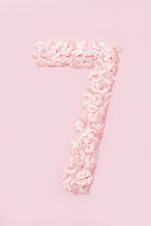 Number seven collected from decorative pink hearts. Isolated on pink backgroundの写真素材