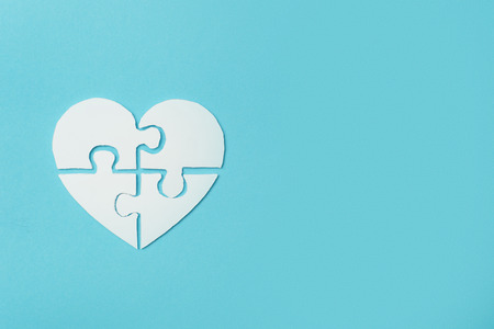 White heart made of symbolic autism puzzle piecesの写真素材