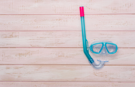 Scuba diving and snorkelling. Diving mask and snorkel on wood backgroundの写真素材