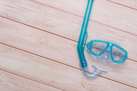 Scuba diving and snorkelling. Diving mask and snorkel on wood backgroundの写真素材
