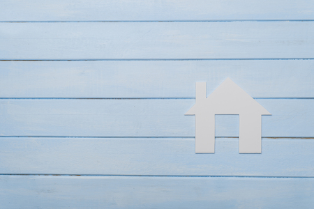 Symbol of the house on blue wooden backgroundの写真素材