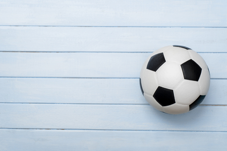 Soccer ball or football on blue wooden floorの写真素材