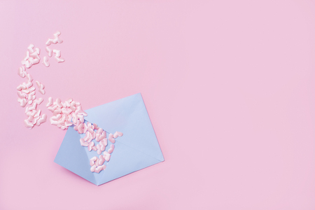 Small pink hearts with envelope, on pink background with copy spaceの写真素材