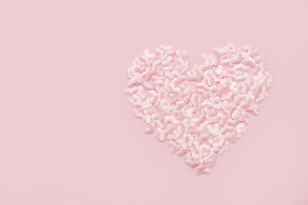 Elements in shape of heart flying on pink background. symbols of love for Happy Women's, Mother's, Valentine's Dayの写真素材