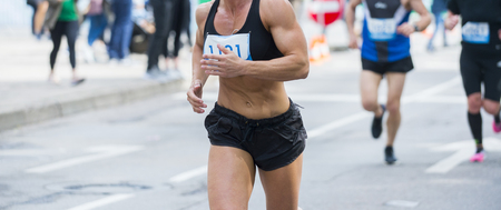 Unrecognizable muscular runner outdoors. Long distance runningの写真素材