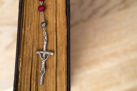 Cross on the Bible on a wooden background. Holy book.の写真素材