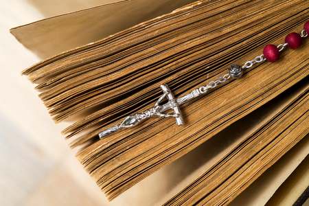 Cross on the Bible on a wooden background. Holy book.の写真素材