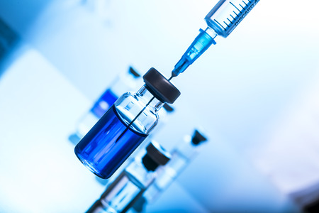 Medical concept Vaccination vaccine vial dose flu shot drug needle syringeの写真素材