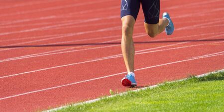 Young sporty man running on sunny dayの写真素材