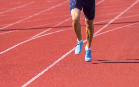 Young sporty man running on sunny dayの写真素材