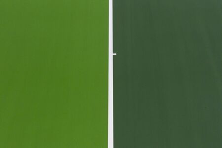 White lines of tennis courts on green floor background and have copy space for design backdrop in your workの写真素材