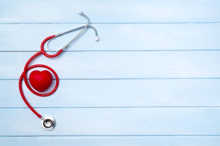 Stethoscope and red heart on blue wooden backgroundの写真素材