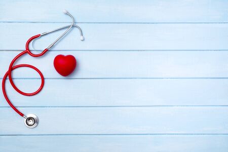 Stethoscope and red heart on blue wooden backgroundの写真素材