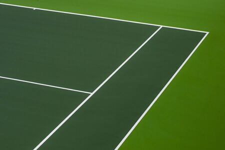 White lines of tennis courts on green floor background and have copy space for design backdrop in your workの写真素材