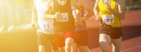 Athletics people running on the track field. Sunny dayの写真素材