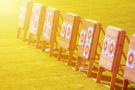 Three archery targets in a row in a grass field on a sunny dayの写真素材
