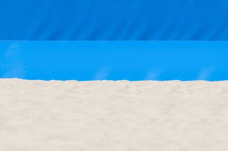 Football, volleyball, handball summer sport. Sandy beach on blue background with copy space for textの写真素材