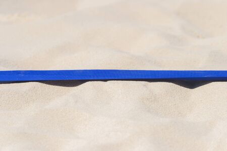 beach volleyball, soccer, handball court up close and in detail with blue plastic line markerの写真素材