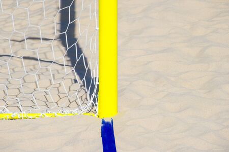 football summer sport. closeup goal net on a sandy beach outdoorの写真素材