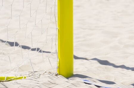 football summer sport. closeup goal net on a sandy beach outdoorの写真素材