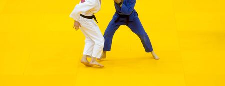 Two judo fighters in white and blue uniform.の写真素材