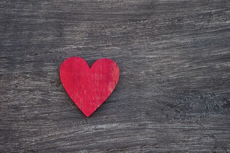 Red heart on wooden table, top view. With space for text. Concept of helpの写真素材