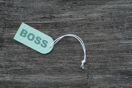 Blank label. With rope on wooden table. Sign that says Boss