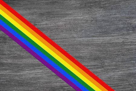 LGBT flag colors over wooden textured background. Gay pride. Top view with space for text.の写真素材