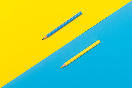 Back to scool - Pencils detail. Colored sharp pencils detail in a row, isolated on blue and yellowの写真素材