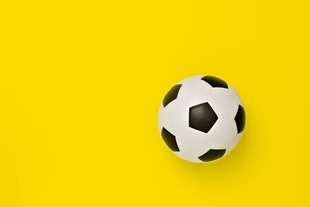 Soccer ball or football on yellow backgroundの写真素材