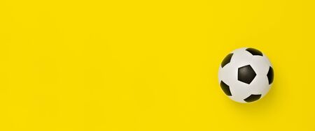 Soccer ball or football on yellow backgroundの写真素材