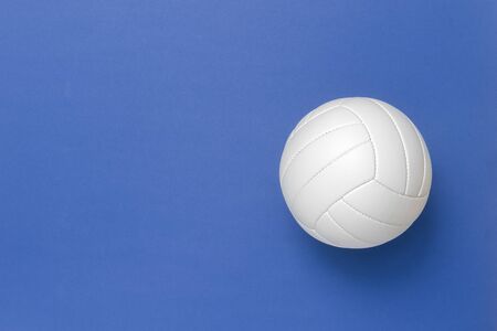 White volleyball leather ball on blue background. Top view.の写真素材