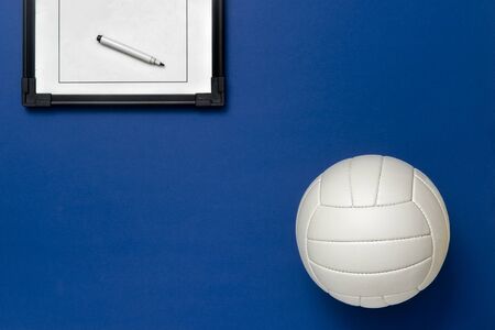 Volleyball and tactical board with marker on blue background. Top viewの写真素材