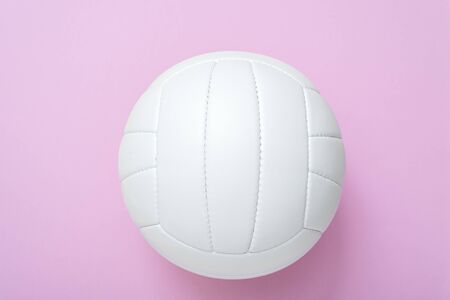 White volleyball leather ball on pink background. Top view.の写真素材