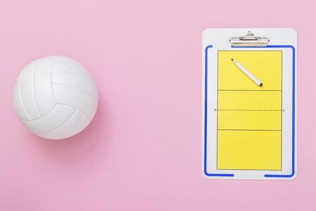 Volleyball and tactical board with marker on pink background. Top viewの写真素材