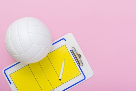 Volleyball and tactical board with marker on pink background. Top viewの写真素材