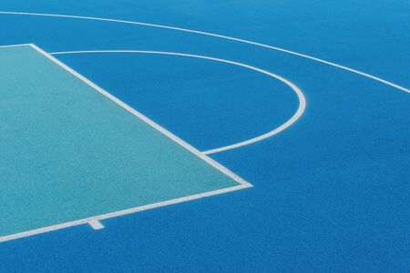 Abstract, blue background of newly made outdoor basketball court. Visible asphalt texture, freshly painted linesの写真素材