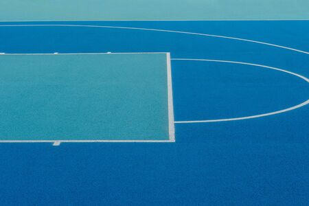 Abstract, blue background of newly made outdoor basketball court. Visible asphalt texture, freshly painted linesの写真素材