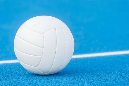 Volleyball ball on blue playground with white lineの写真素材