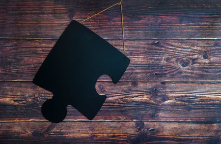 Puzzle piece on wooden background. Autism Spectrum Disorder (ASD). Autism awareness. Concept of...
